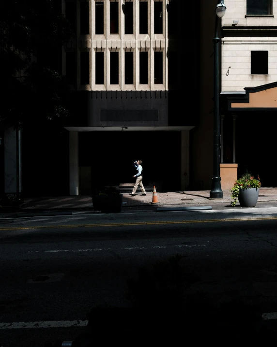 a person is walking alone on the side walk