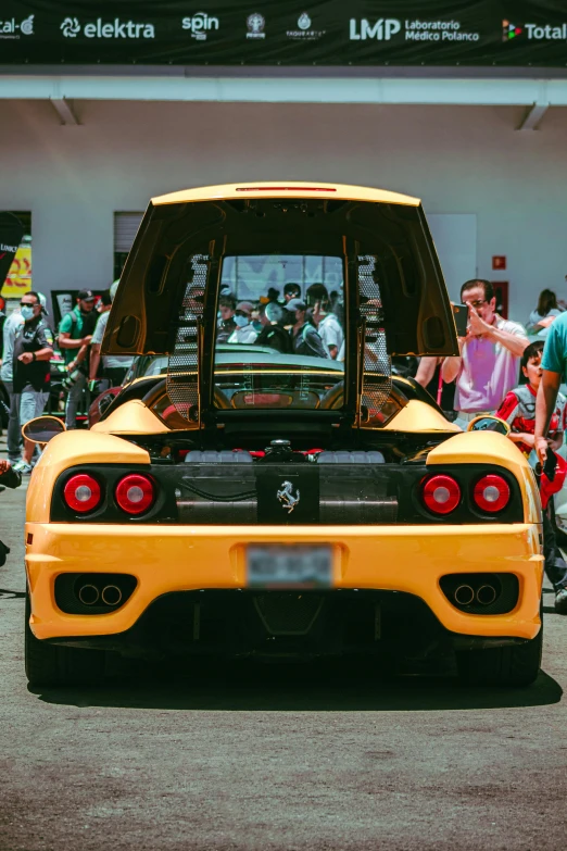 a man is looking at the back of a modified sports car