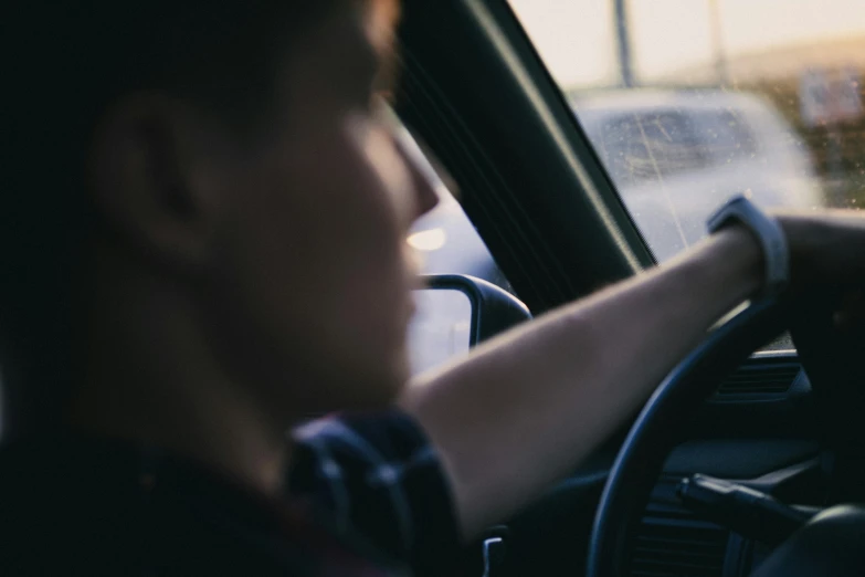 a man is driving a car on a freeway