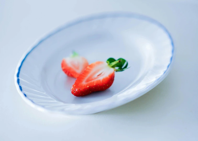 strawberries with leaves on a plate on a table