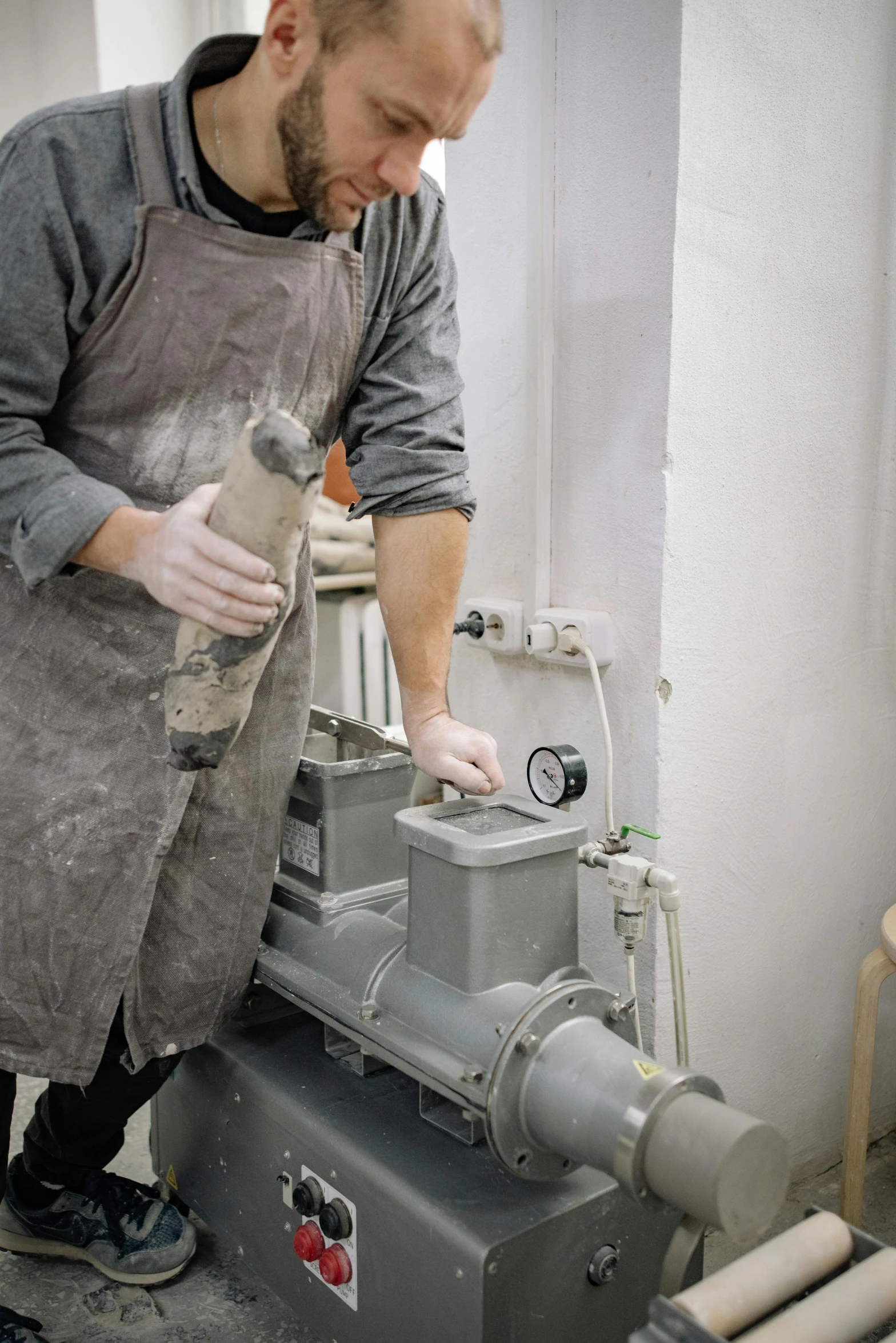 a man using a power tool on the back of a machine