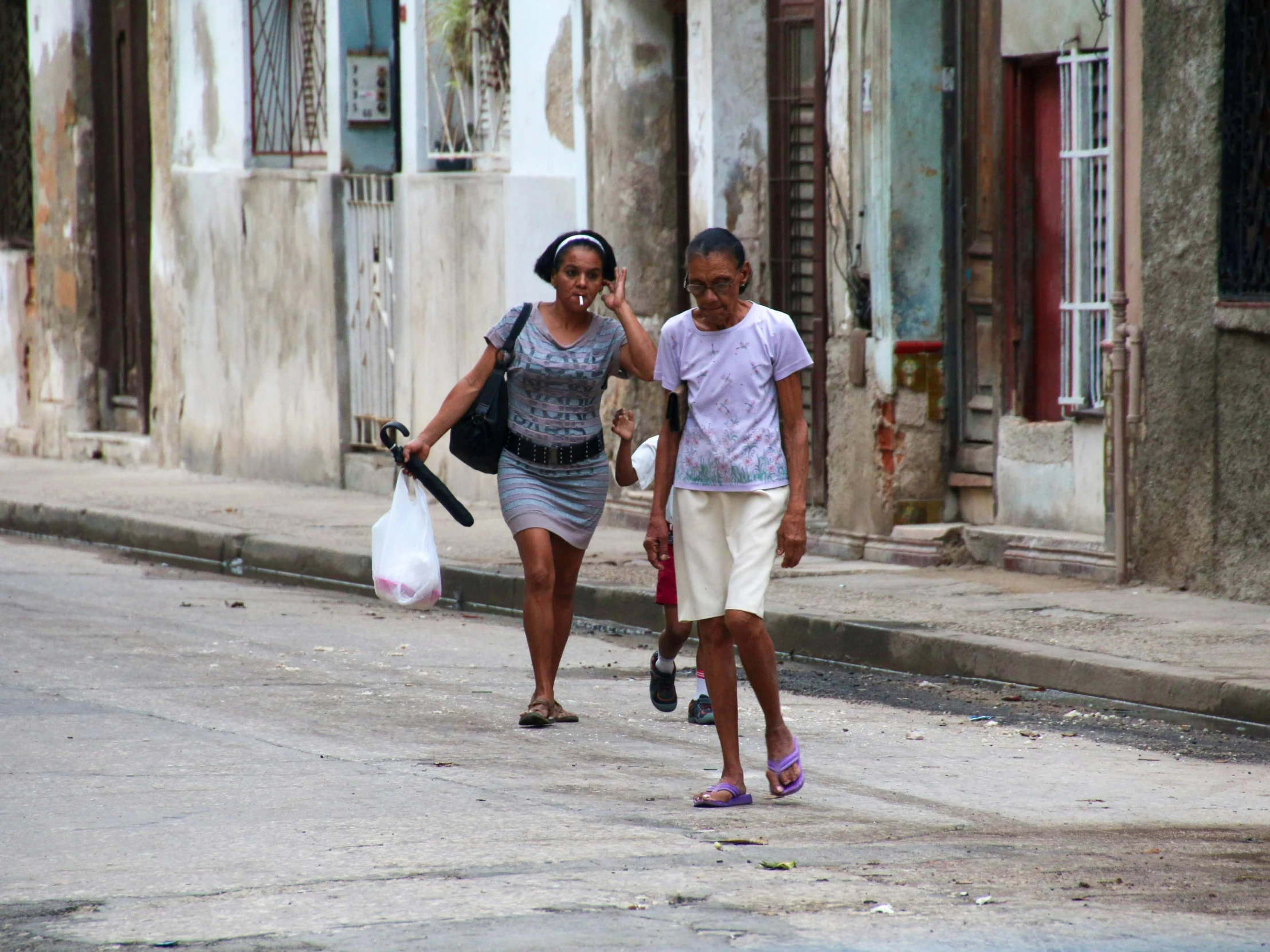 two people are walking down the street in a foreign country