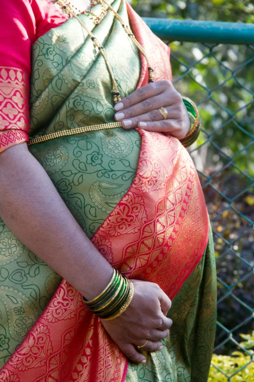 a woman in indian garb, holding her back