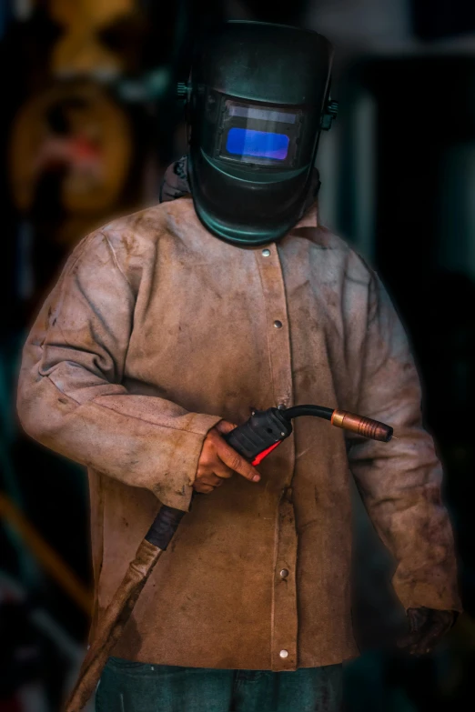 a person in a suit wearing a welding helmet and holding a wire