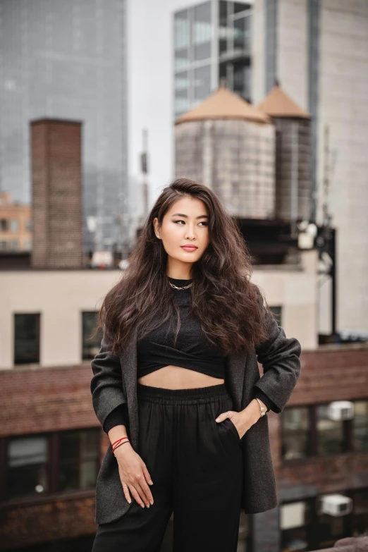 young lady posing with her long dark hair in a high way