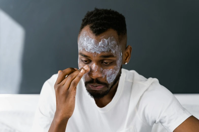 a man is putting on a face mask