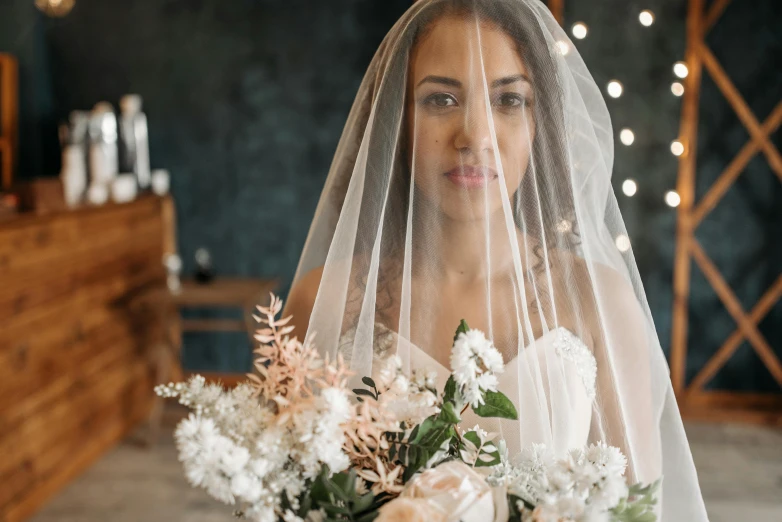 a bride with a veil and flowers