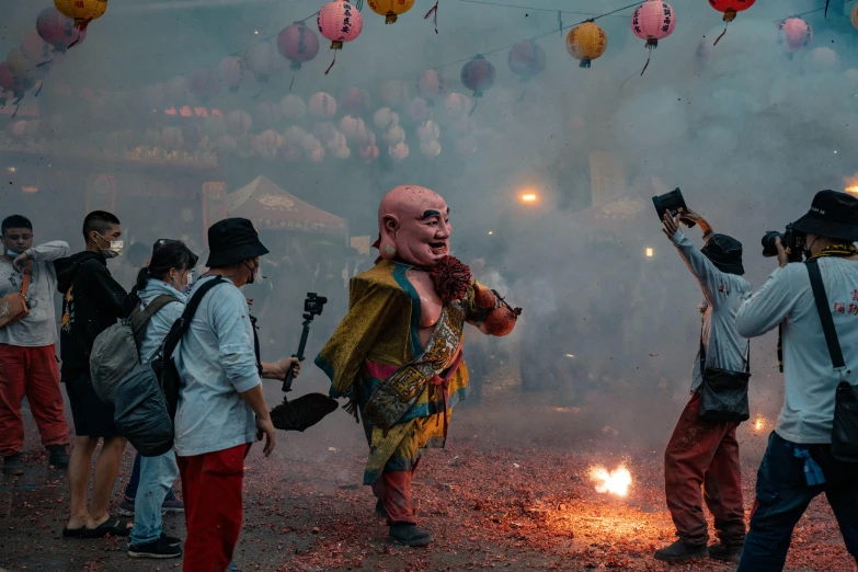 people with backpacks and helmets on are standing around a fire