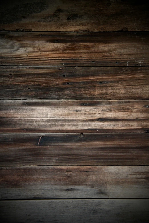 a cell phone is laying on a wooden surface