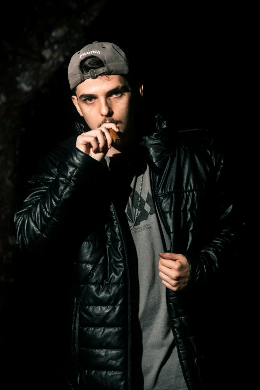 a man in black jacket smoking a cigarette