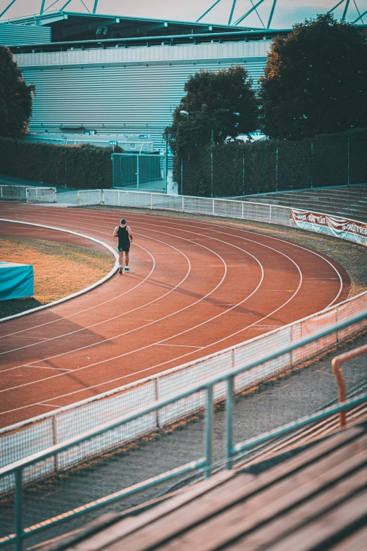 a man is walking towards a running track