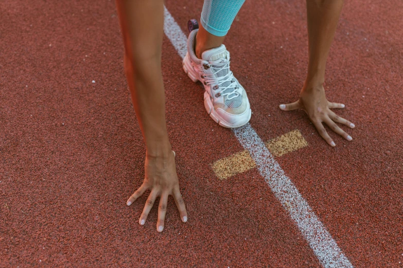 the hands of a female tennis player touching the tennis ball