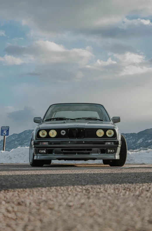 a car parked in front of a large snowy mountain