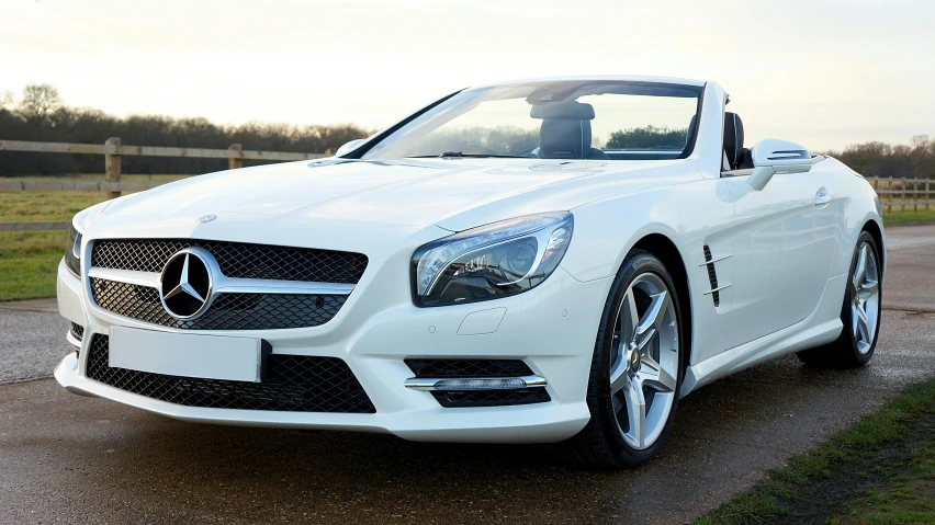 white car sitting in a parking lot on gravel