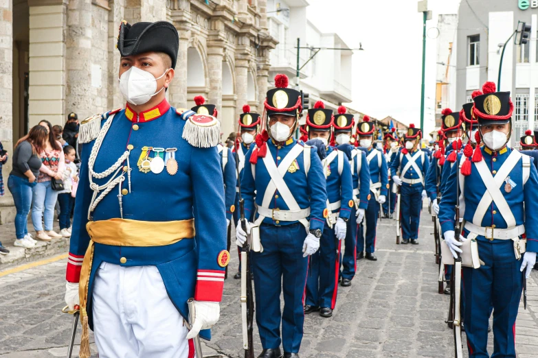 group of men in uniform marching down the street