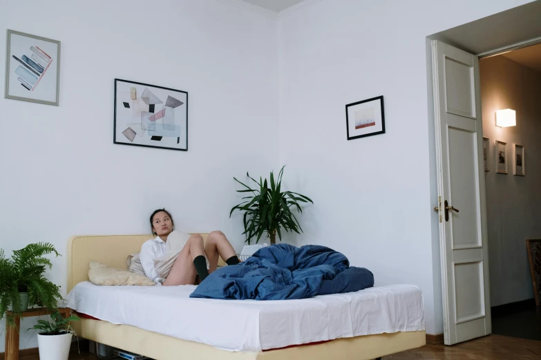 woman resting on her bed looking at soing off camera