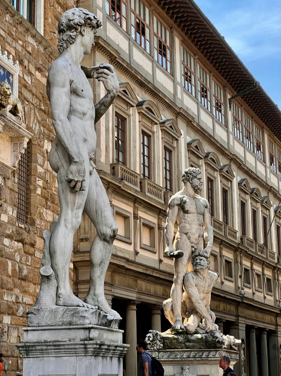 several sculptures and statues in front of an old building