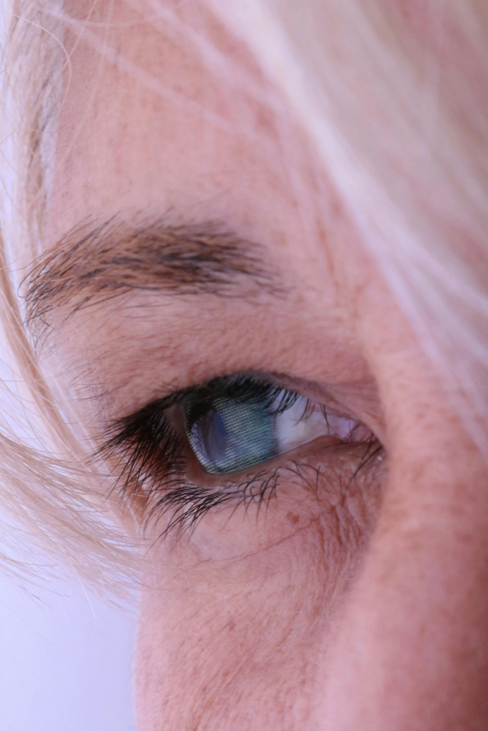 the eye of an old blond woman