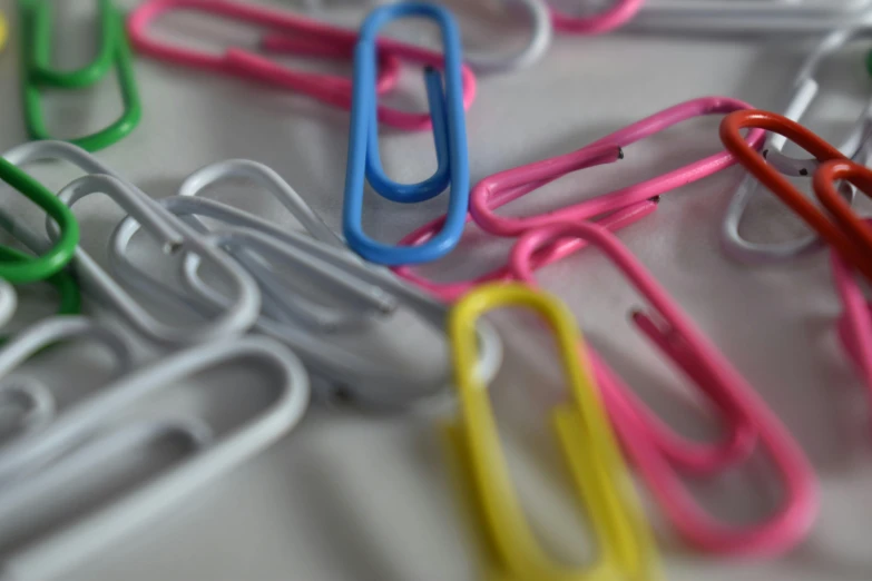 these paper clip holders are organized on the table