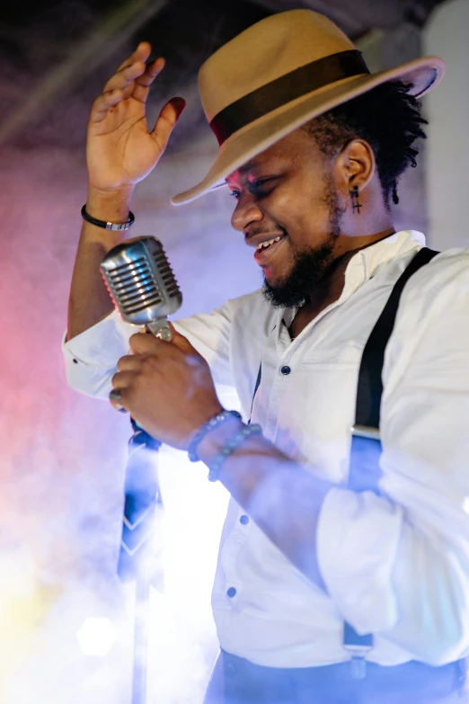 a man holding a microphone while standing on a stage