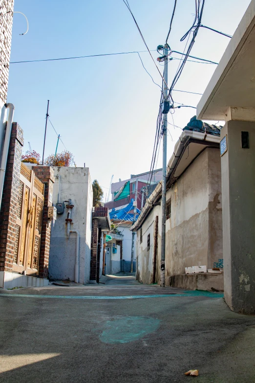 the street is lined with small houses and buildings