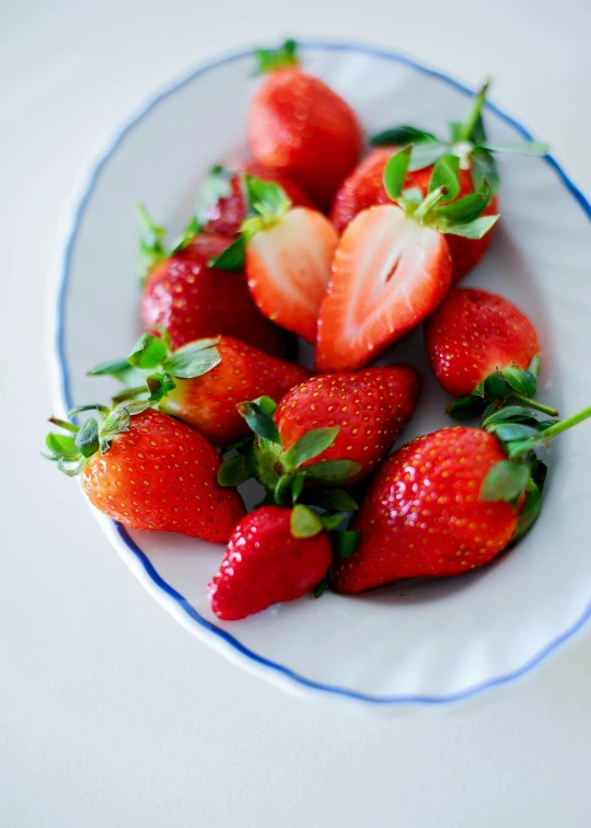 a bunch of strawberries that are on a plate