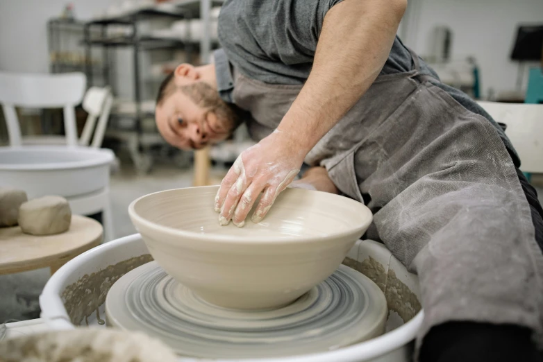 a person is preparing soing on a pottery wheel