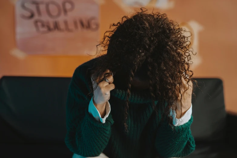 a young woman is leaning her head against the back of a chair