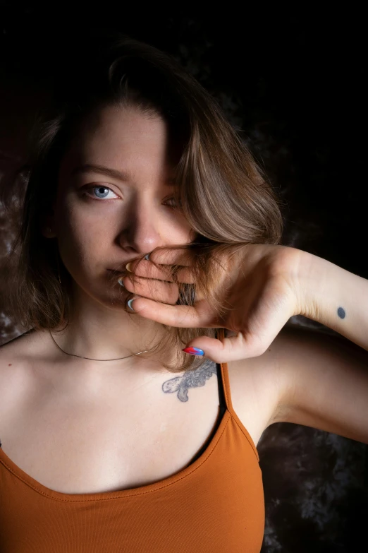 a young woman with a cigarette in her mouth