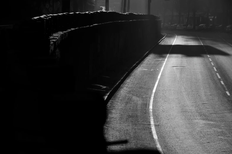 black and white po of street light next to roadway