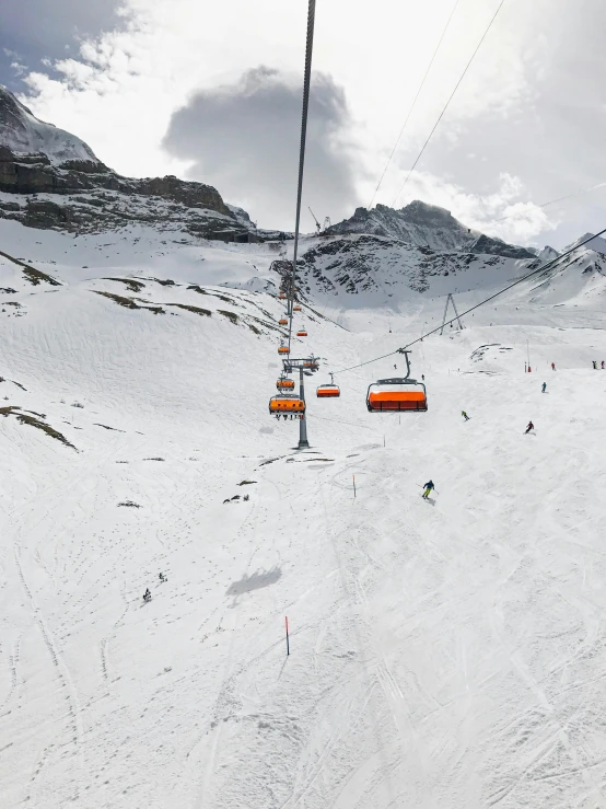 a ski lift is moving up the side of a hill