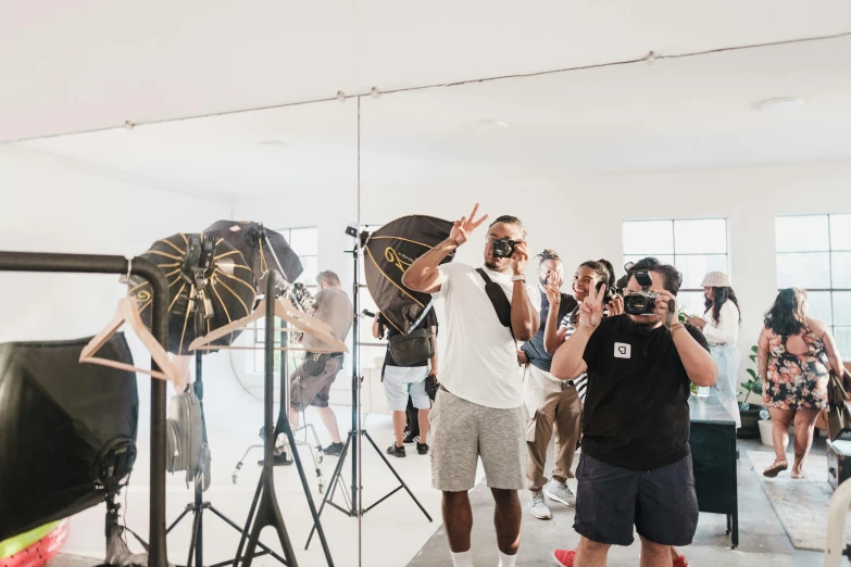 people in a white room with camera equipment