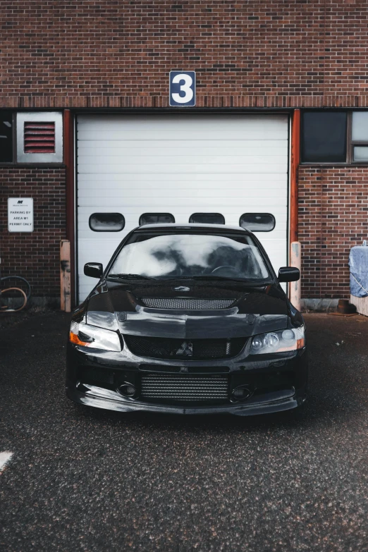 a car is parked in front of a garage