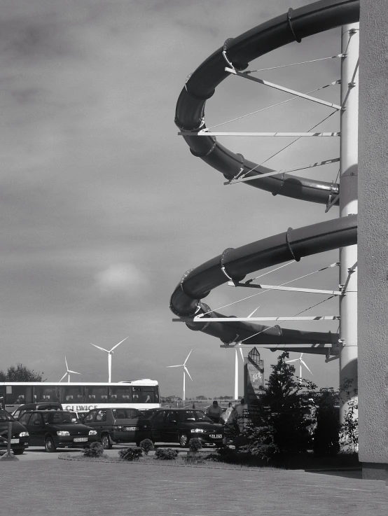 this is an image of a bus driving by a wind mill