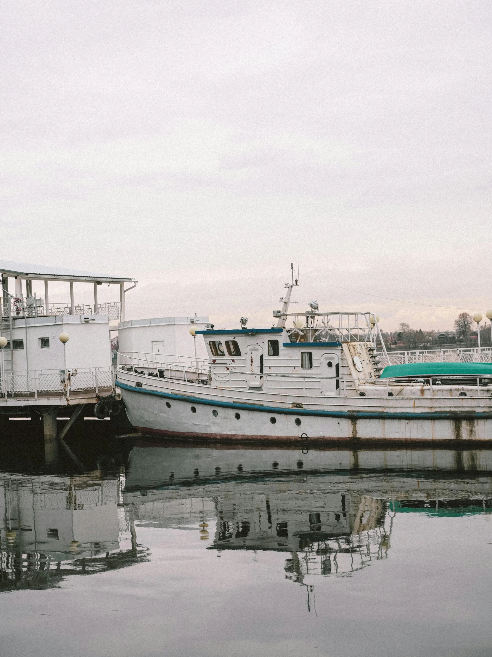 three boats are docked in an ocean by the docks