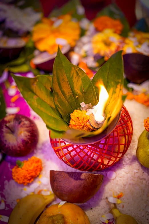 there is a vase with flowers and other fruits next to it