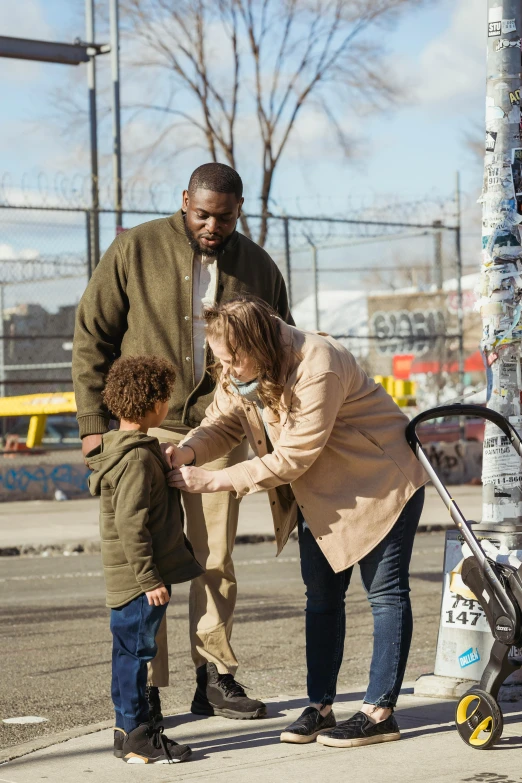 a man and two little boys playing with a woman