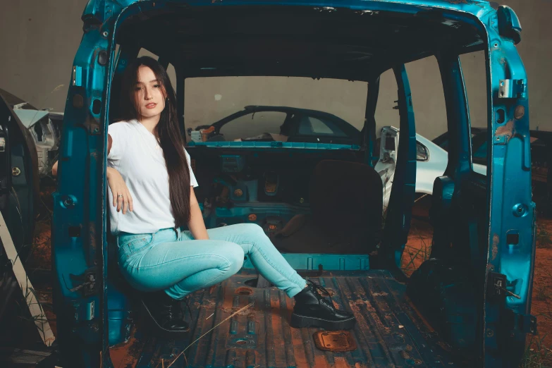 woman sitting on the inside of a broken vehicle