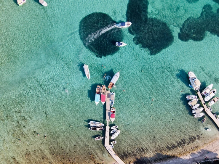 aerial view of boats in clear blue water