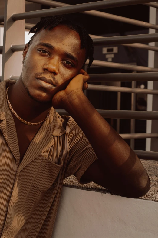 a black man wearing a striped shirt and a collared shirt