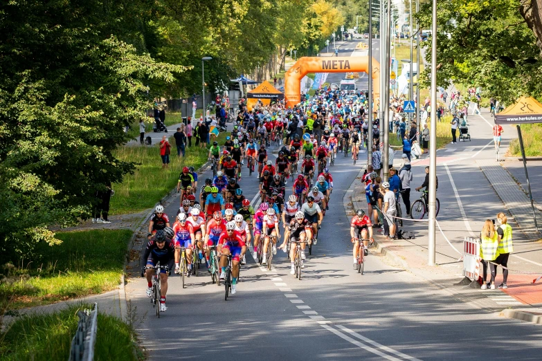 many people are running down the street and some are riding bicycles