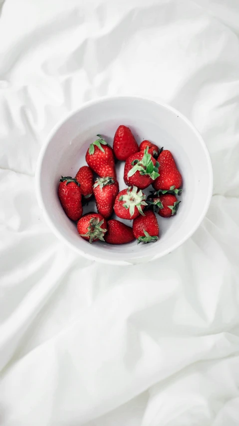 a small bowl with some very small strawberries