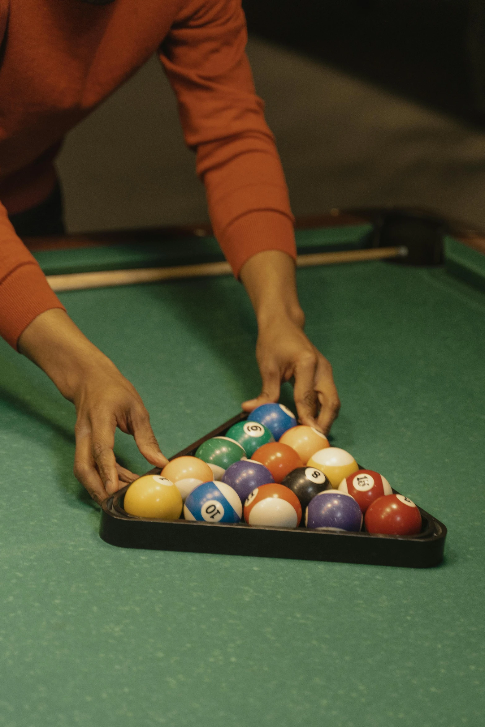 a person playing billiard in a pool hall