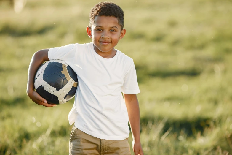 the  in the white shirt holds his soccer ball