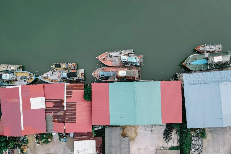 a few small boats in a harbor next to many houses