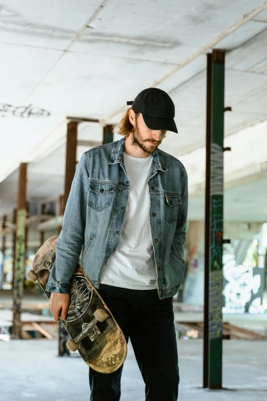 the young man is walking with his skateboard