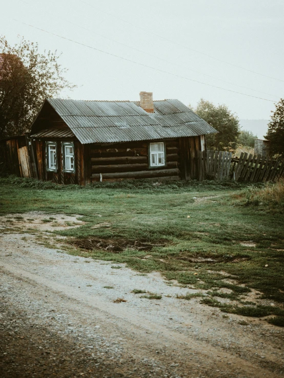 a cabin and barn are on the grass