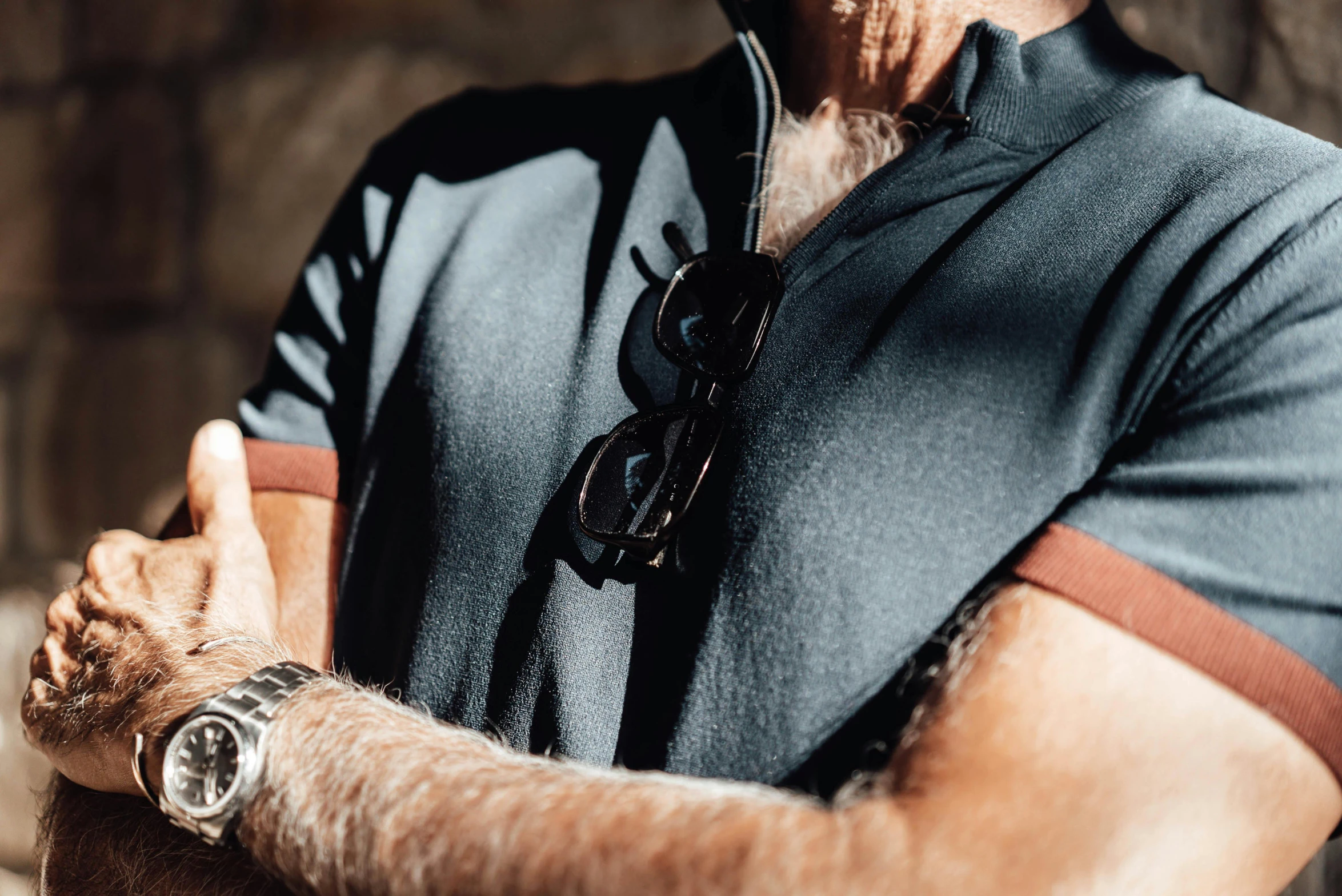 man standing and gesturing as he holds his watch