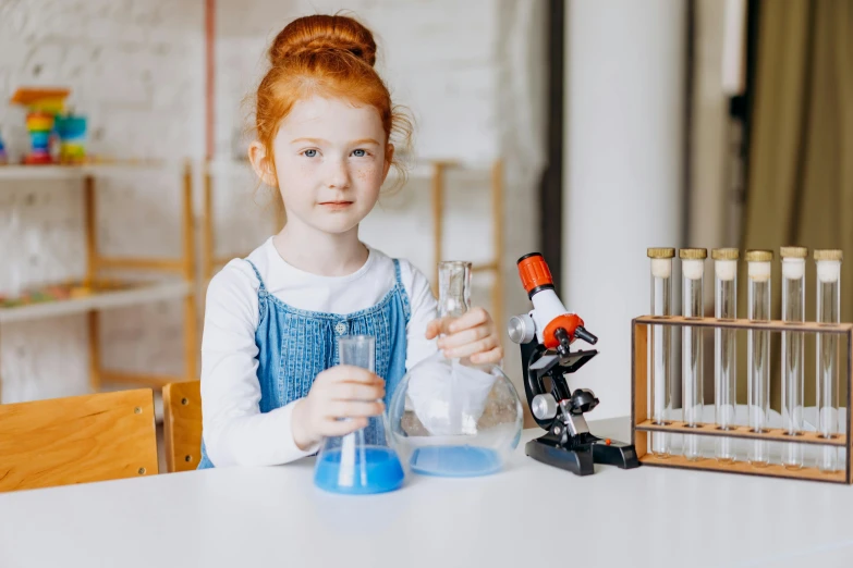 a girl at the table doing craft work