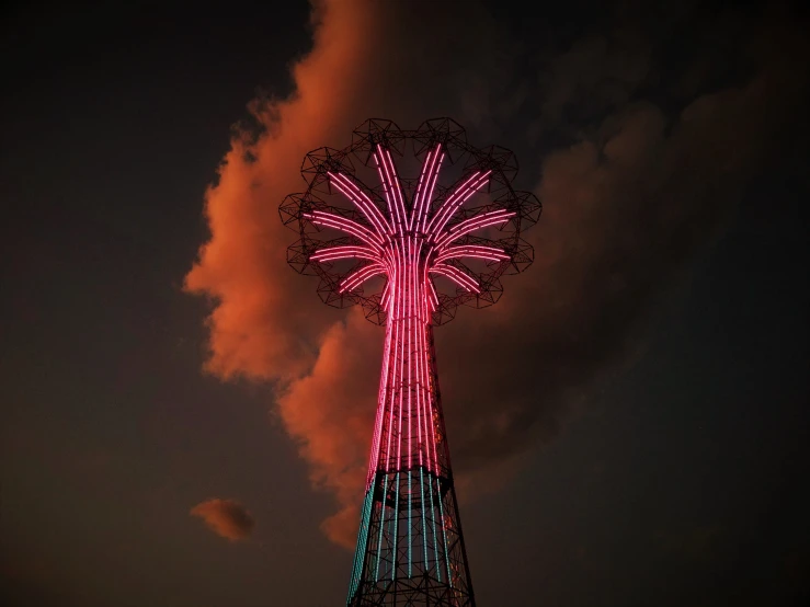 a large pink and black lighted ferris wheel